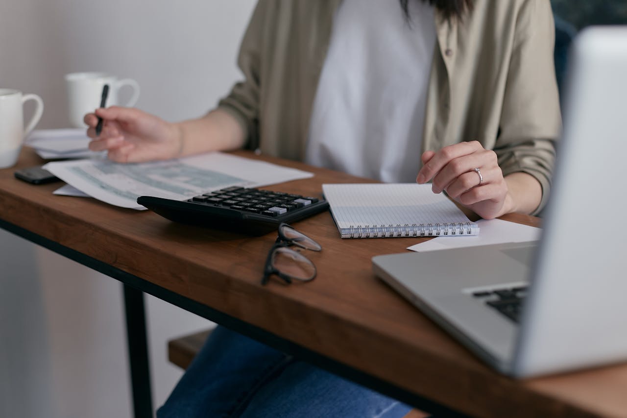 Woman at a desk with calculator